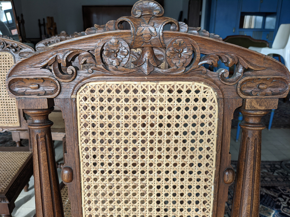 12 oak caned chairs — Detail of the skillfully cut and engraved top