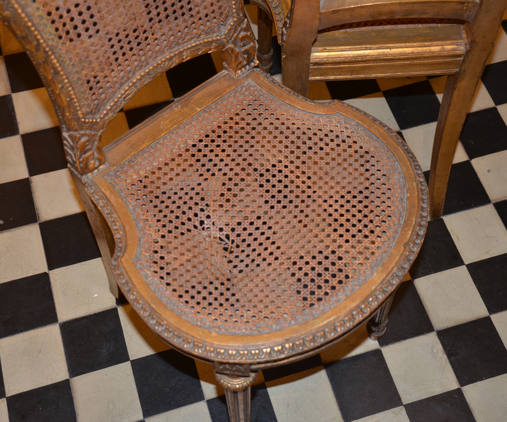 A pair of Napoleon III style carved gilt wood chairs — Detail of one seat, with damage