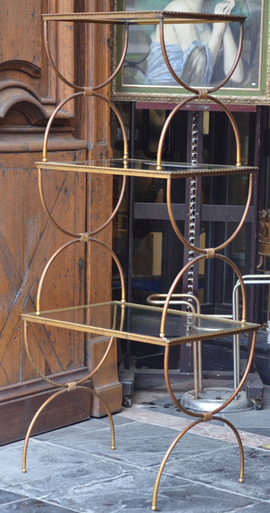 A nest of three occasional tables — Trois tables à gigogne en métal patiné et verre, années 40-50