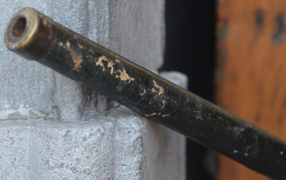 A wooden blowing pipe — Detail of the end with metal final