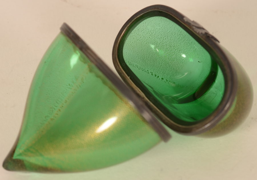 A glass heart shaped box — In green glass with a distinct dispersed gold pattern