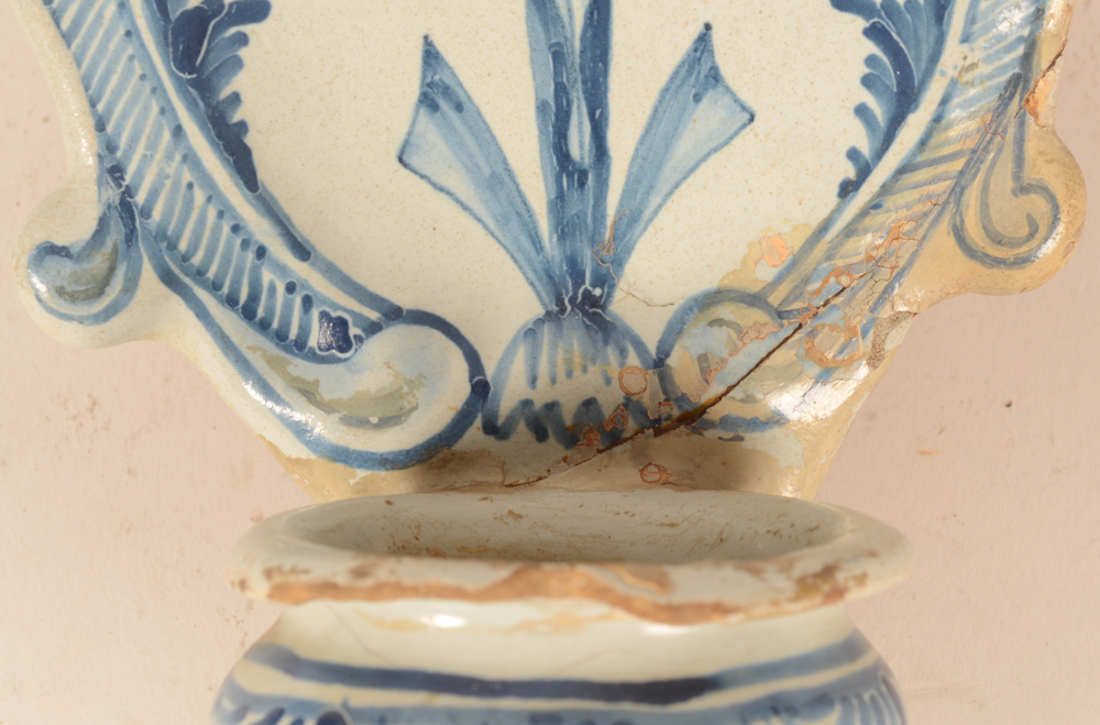 holy water stoup — detail of the damage and old restauration 