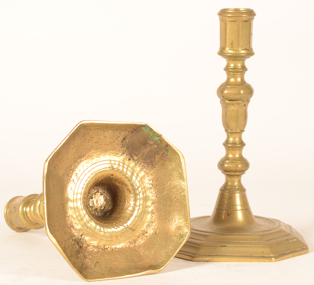L XIV Candlesticks — One of the candlesticks showing an old repair to the base.