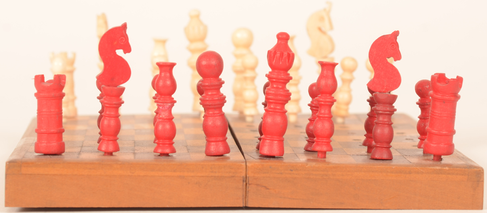 Travel chess set — Deatil of the red pawns, right horse restored