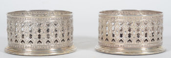 Wilkins a pair of open worked silver and wood wine coasters