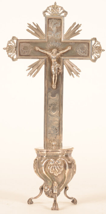A silver holy water stoup in the baroque style